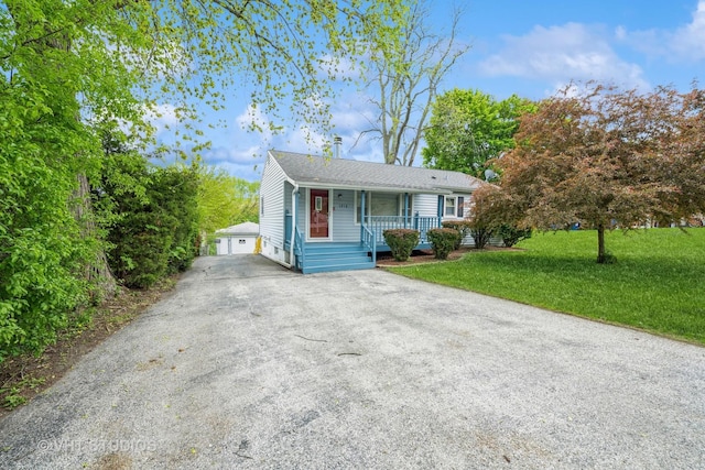 1216 Maple St, Lake In The Hills, IL 60156 - view of front of property featuring a porch, a front yard, a detached garage, roof with shingles, and an outdoor structure