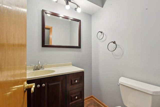 half bathroom with toilet and vanity