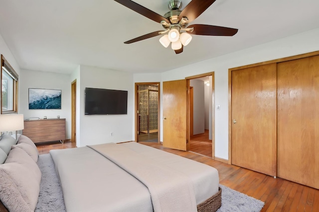 bedroom with ceiling fan, connected bathroom, and light wood-style flooring