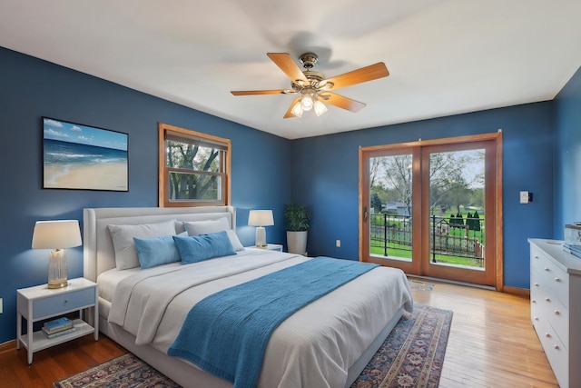 bedroom featuring baseboards, ceiling fan, access to outside, and light wood-style flooring