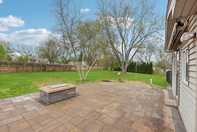 view of patio featuring a fenced backyard and an outdoor fire pit