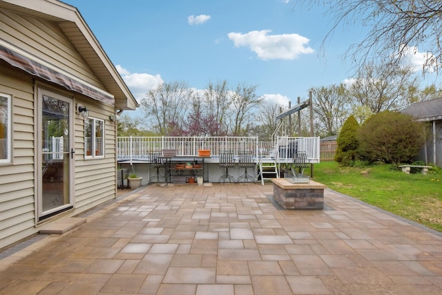 view of patio with a wooden deck and outdoor dining area