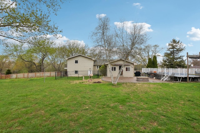 back of property featuring a lawn, an outdoor fire pit, a fenced backyard, and an outbuilding
