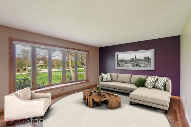 living area with baseboards, wood finished floors, and a wealth of natural light