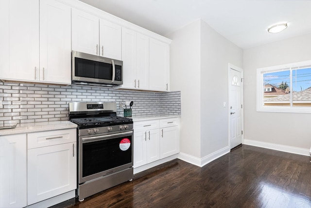 7740 S Vernon Ave, Chicago, IL 60619 - kitchen featuring tasteful backsplash, stainless steel appliances, dark wood finished floors, baseboards, and white cabinetry