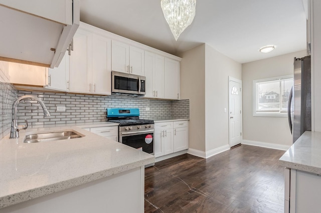 7740 S Vernon Ave, Chicago, IL 60619 - kitchen featuring white cabinets, stainless steel appliances, a sink, baseboards, and decorative backsplash