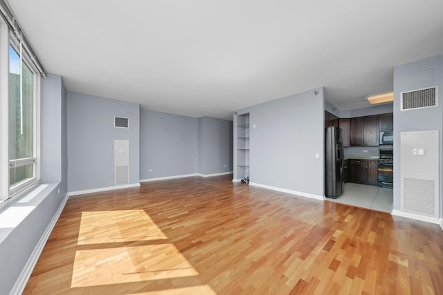 33 W Ontario St Unit 46A, Chicago, IL 60654 - unfurnished living room featuring light wood-style flooring, visible vents, and baseboards