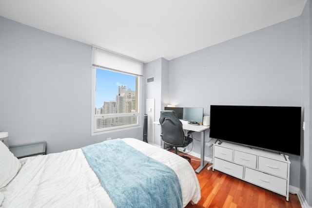 33 W Ontario St Unit 46A, Chicago, IL 60654 - bedroom with baseboards, wood finished floors, and visible vents