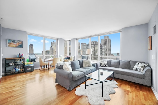 33 W Ontario St Unit 46A, Chicago, IL 60654 - living room with a city view, wood finished floors, and visible vents