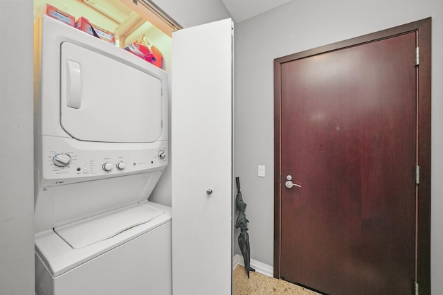 33 W Ontario St Unit 46A, Chicago, IL 60654 - laundry room featuring baseboards, stacked washer / dryer, and laundry area