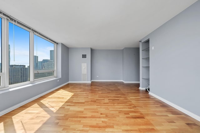 33 W Ontario St Unit 46A, Chicago, IL 60654 - empty room featuring light wood finished floors and baseboards
