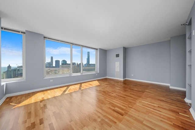 33 W Ontario St Unit 46A, Chicago, IL 60654 - spare room with light wood finished floors, baseboards, and a wealth of natural light
