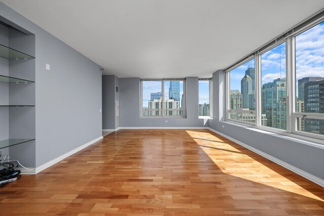 33 W Ontario St Unit 46A, Chicago, IL 60654 - unfurnished room featuring plenty of natural light, light wood finished floors, and a view of city