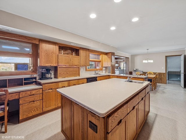 kitchen featuring a sink, brown cabinetry, recessed lighting, and a wealth of natural light