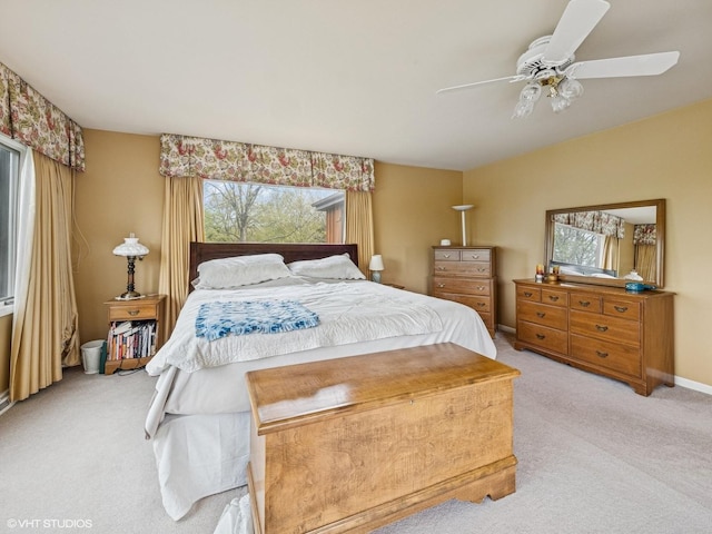 bedroom featuring a ceiling fan and light carpet