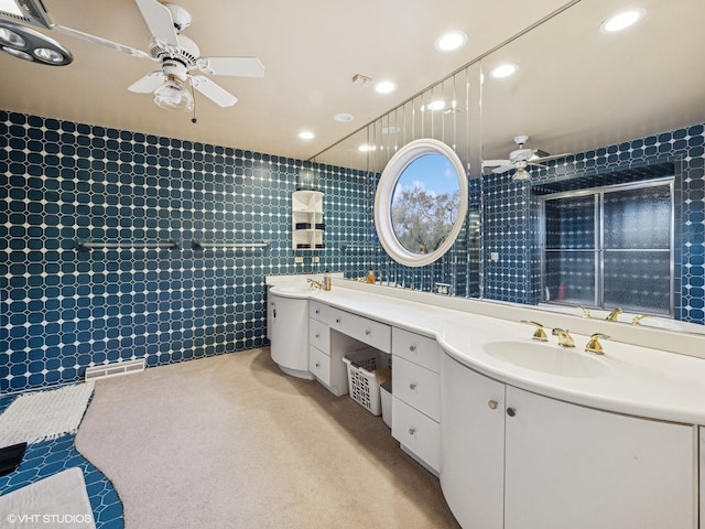 bathroom featuring double vanity, ceiling fan, visible vents, and a sink