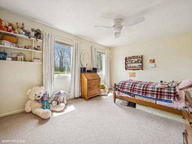bedroom with baseboards, a ceiling fan, and light carpet