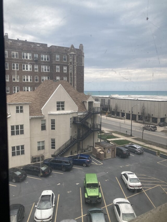 6300 N Sheridan Rd Unit 517, Chicago, IL 60660 - view of building exterior featuring uncovered parking and a water view