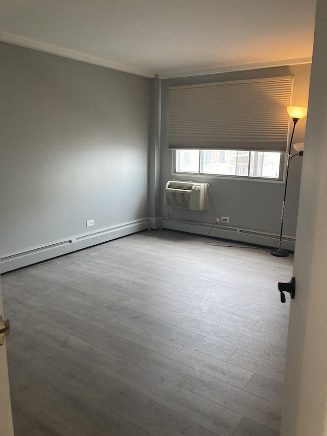 6300 N Sheridan Rd Unit 517, Chicago, IL 60660 - empty room featuring wood finished floors, an AC wall unit, and baseboard heating