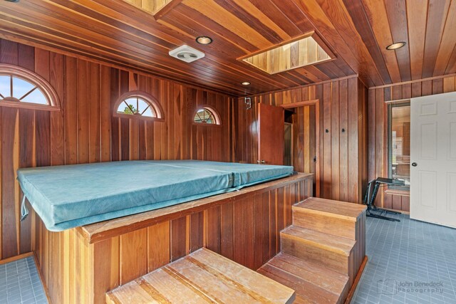 misc room featuring wooden ceiling, wooden walls, plenty of natural light, and recessed lighting