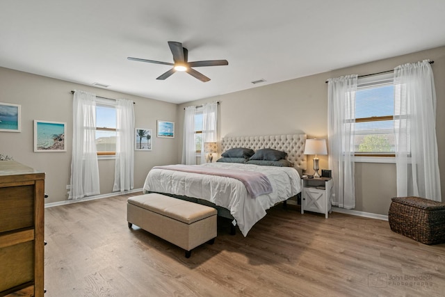 bedroom featuring light wood-style floors, baseboards, and ceiling fan
