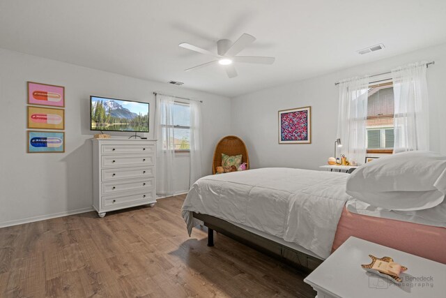 bedroom featuring wood finished floors, ceiling fan, and baseboards