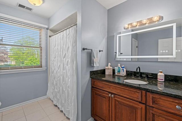 full bathroom with baseboards, vanity, and tile patterned floors