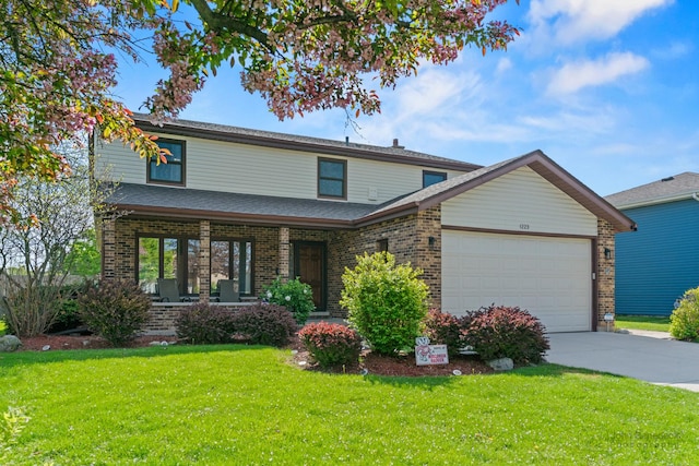 traditional home featuring a garage, a front yard, covered porch, brick siding, and concrete driveway