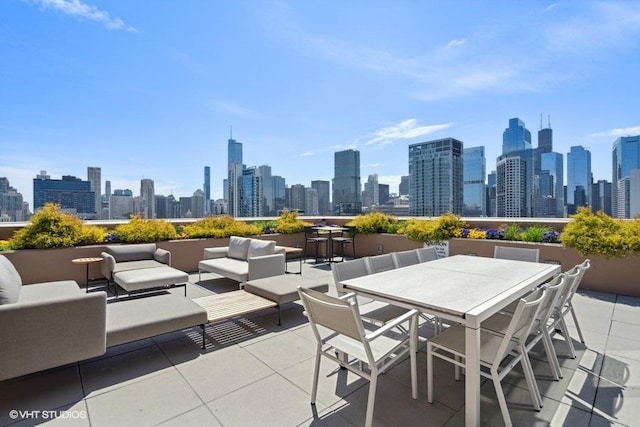 view of patio / terrace featuring an outdoor living space, a city view, and outdoor dining area