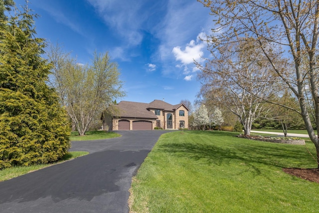 4N481 Citation Ln, Elburn, IL 60119 - traditional-style home featuring aphalt driveway, a front yard, an attached garage, and stone siding