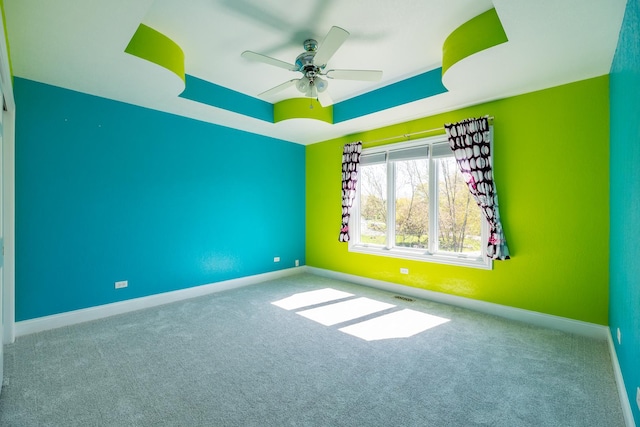 4N481 Citation Ln, Elburn, IL 60119 - spare room featuring ceiling fan, baseboards, a tray ceiling, and carpet floors