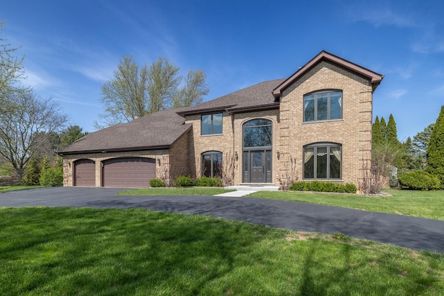 4N481 Citation Ln, Elburn, IL 60119 - view of front of house with a front lawn, an attached garage, aphalt driveway, and brick siding