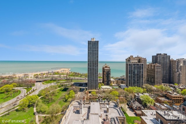 birds eye view of property with a city view and a water view