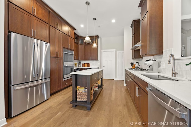 3307 Rosecroft Ln, Naperville, IL 60564 - kitchen with stainless steel appliances, a sink, light wood finished floors, backsplash, and decorative light fixtures