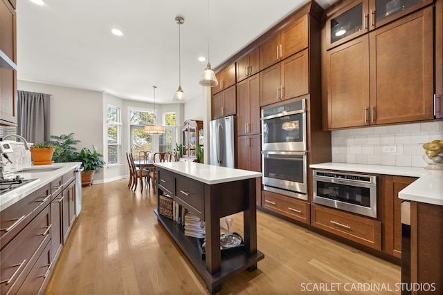 3307 Rosecroft Ln, Naperville, IL 60564 - kitchen with appliances with stainless steel finishes, a sink, backsplash, light wood-style flooring, and recessed lighting