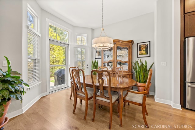 3307 Rosecroft Ln, Naperville, IL 60564 - dining area with light wood-style flooring, baseboards, and a chandelier