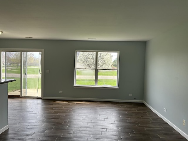 spare room featuring baseboards and wood tiled floor