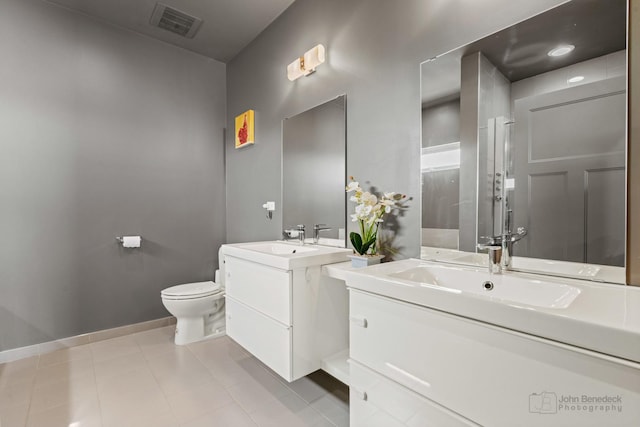 full bathroom with toilet, two vanities, a sink, and visible vents