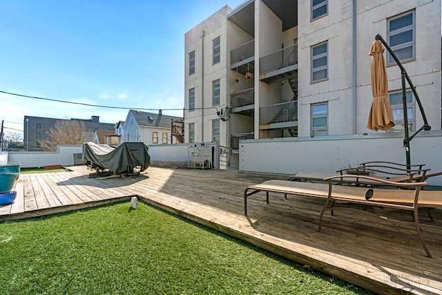 deck featuring a yard and fence