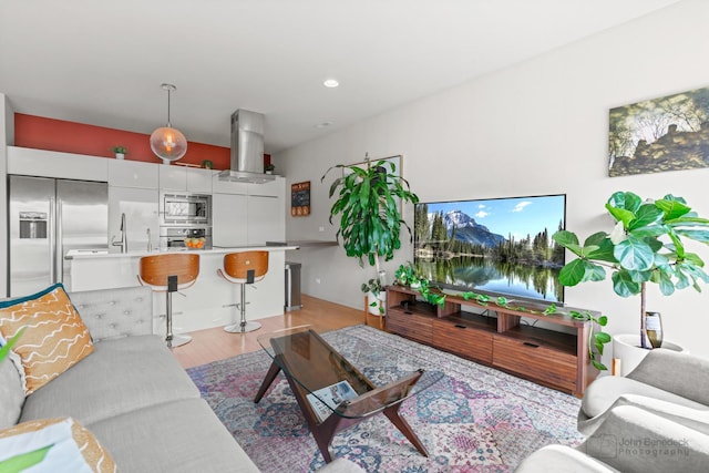 living room with recessed lighting and light wood-type flooring