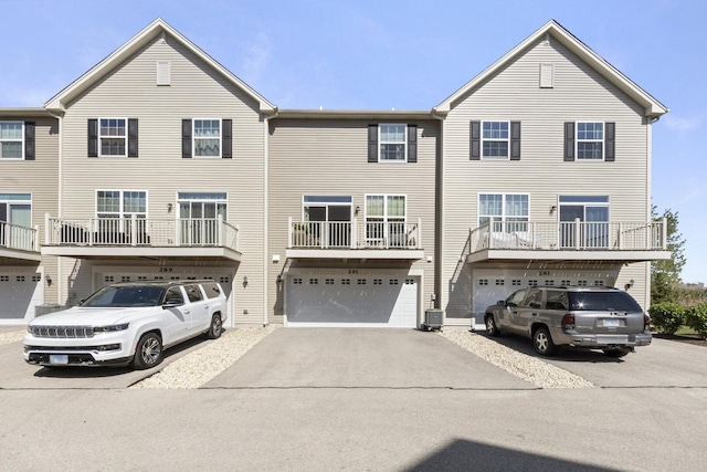 291 Lakeshore Dr, Oswego, IL 60543 - view of front of house featuring an attached garage, central AC unit, and driveway