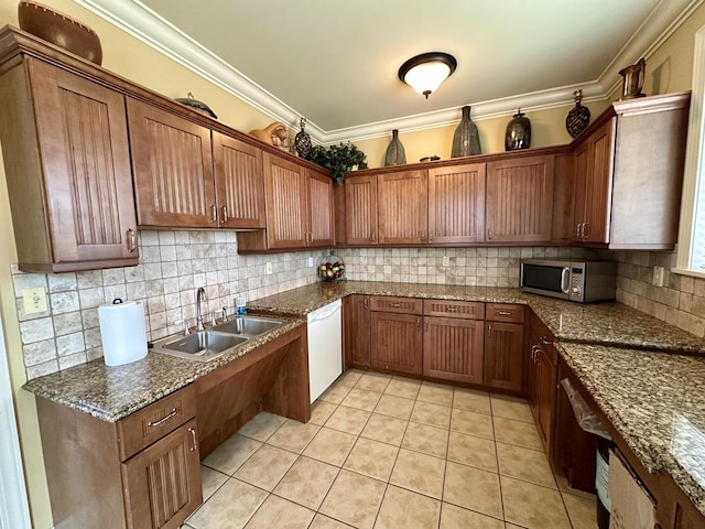 291 Lakeshore Dr, Oswego, IL 60543 - kitchen featuring a sink, white dishwasher, stainless steel microwave, decorative backsplash, and light tile patterned floors