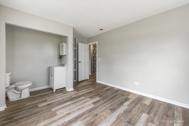 unfurnished bedroom featuring baseboards and wood finished floors
