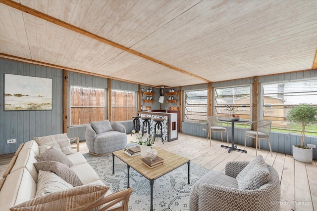 living room featuring wooden walls, hardwood / wood-style flooring, and wooden ceiling