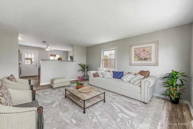 living room featuring baseboards and wood finished floors