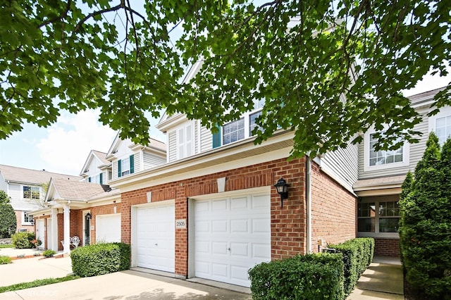 2505 Camberley Cir Unit 3-813, Westchester, IL 60154 - view of home's exterior featuring brick siding, a garage, and concrete driveway