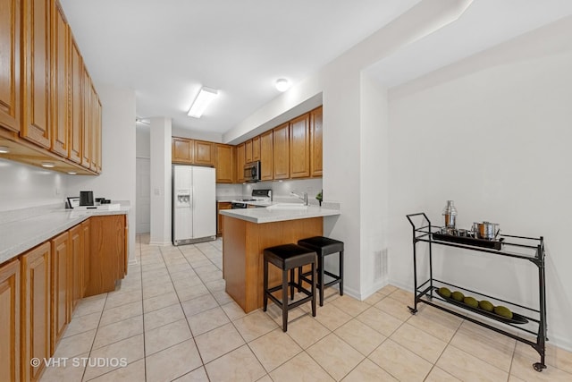 2505 Camberley Cir Unit 3-813, Westchester, IL 60154 - kitchen featuring white refrigerator with ice dispenser, stove, a sink, stainless steel microwave, and a breakfast bar area