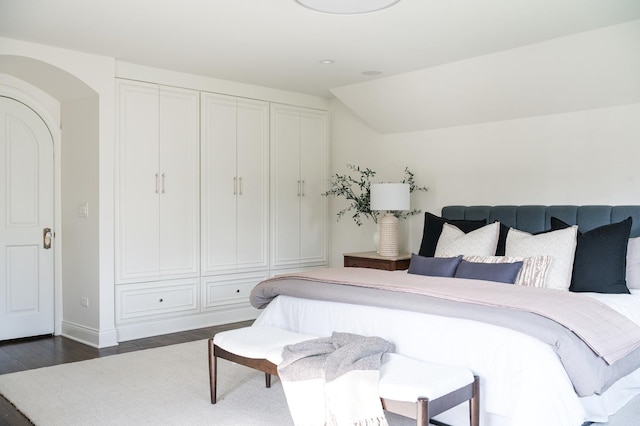 180 De Windt Rd, Winnetka, IL 60093 - bedroom featuring baseboards, dark wood-style flooring, and arched walkways