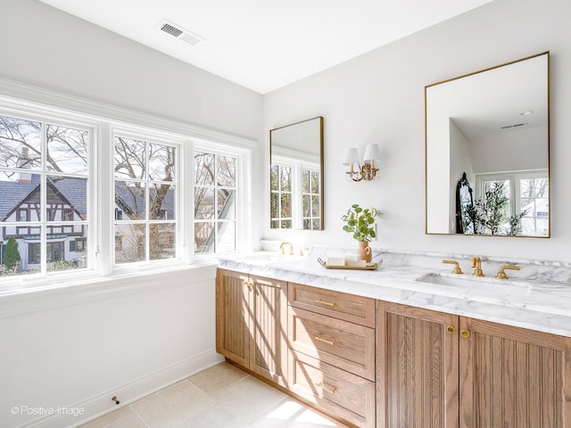 180 De Windt Rd, Winnetka, IL 60093 - full bath with double vanity, baseboards, a sink, and a healthy amount of sunlight