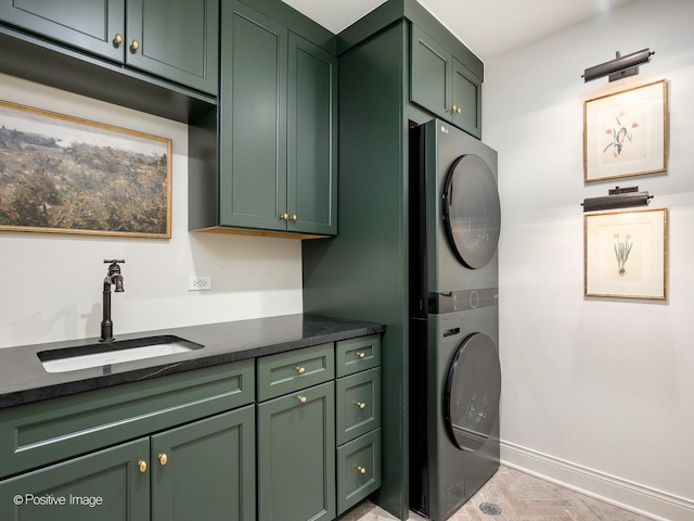 180 De Windt Rd, Winnetka, IL 60093 - laundry room featuring a sink, baseboards, stacked washer and clothes dryer, and cabinet space